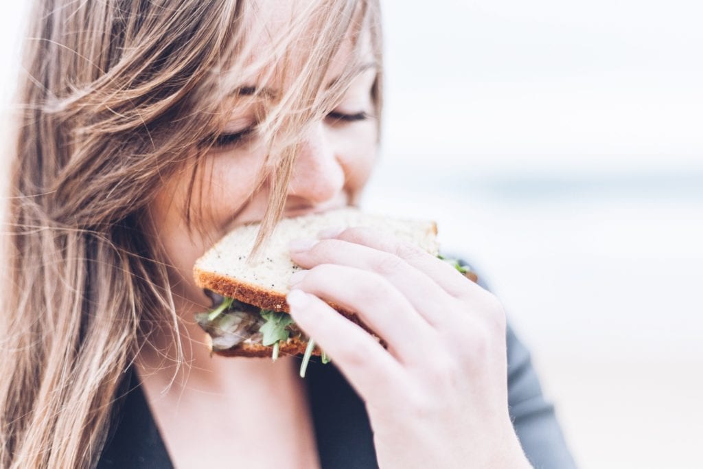 Healthy Traveling eating sandwich