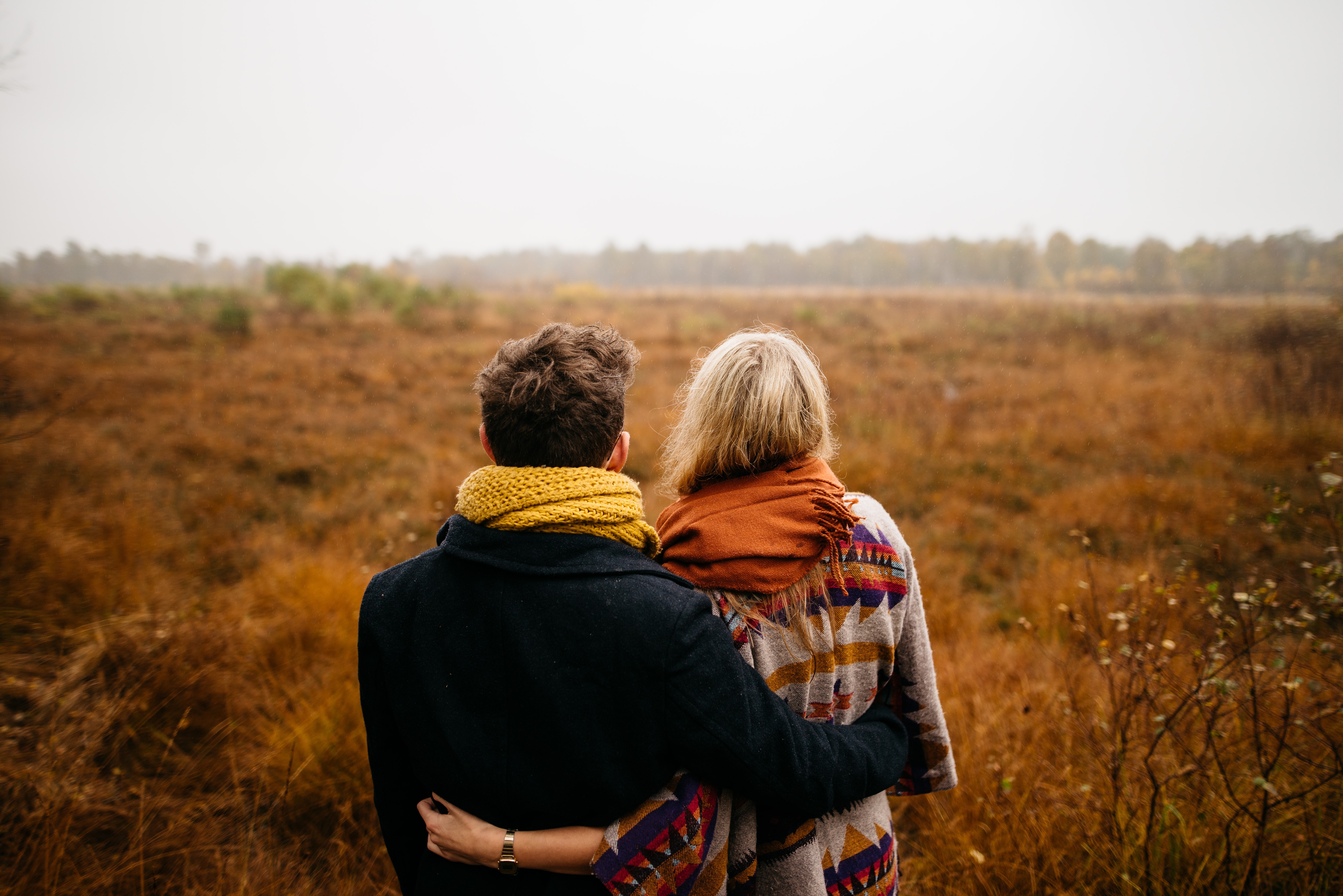 Fall photos couple looking over pasture