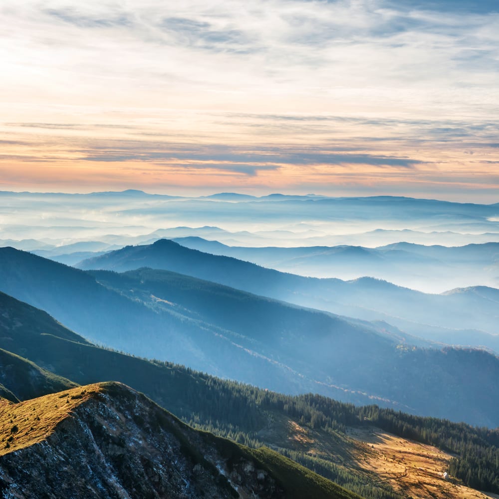 Blue mountains and hills over beautiful sunset a perfect winter vacation in USA