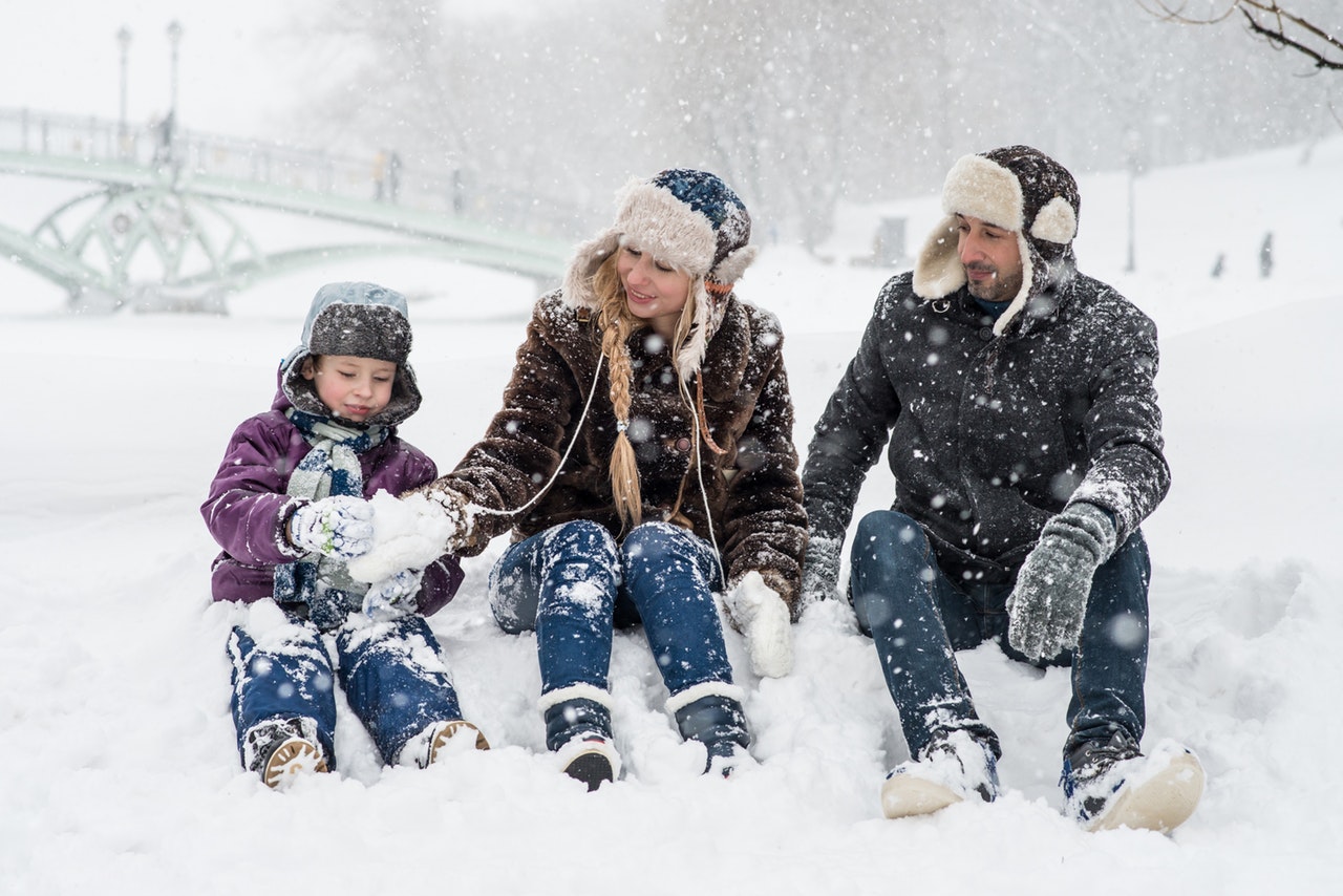 family playing in the snow