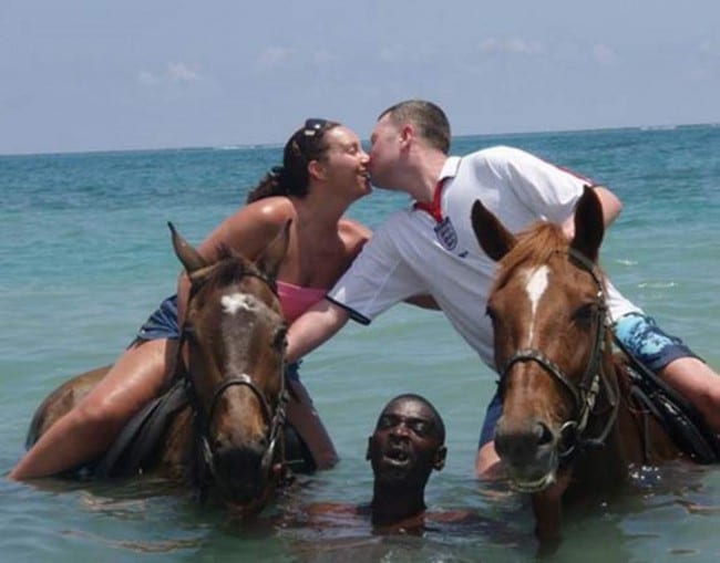 couple riding horses and kissing