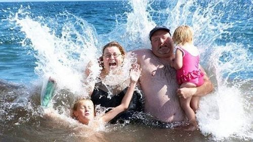 family splashing making an awkward vacation photo