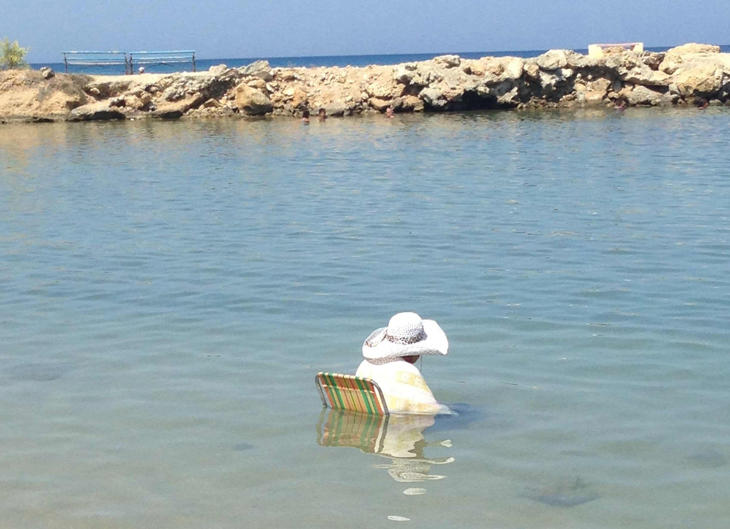 woman sitting in a deck chair in the sea