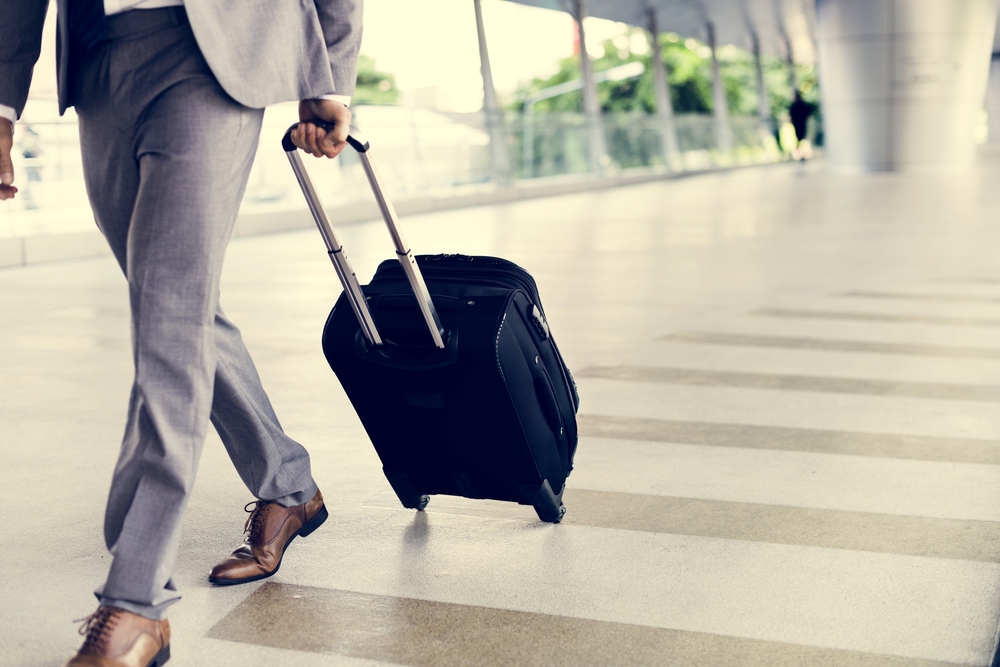 packing hacks for business travelers businessman with luggage