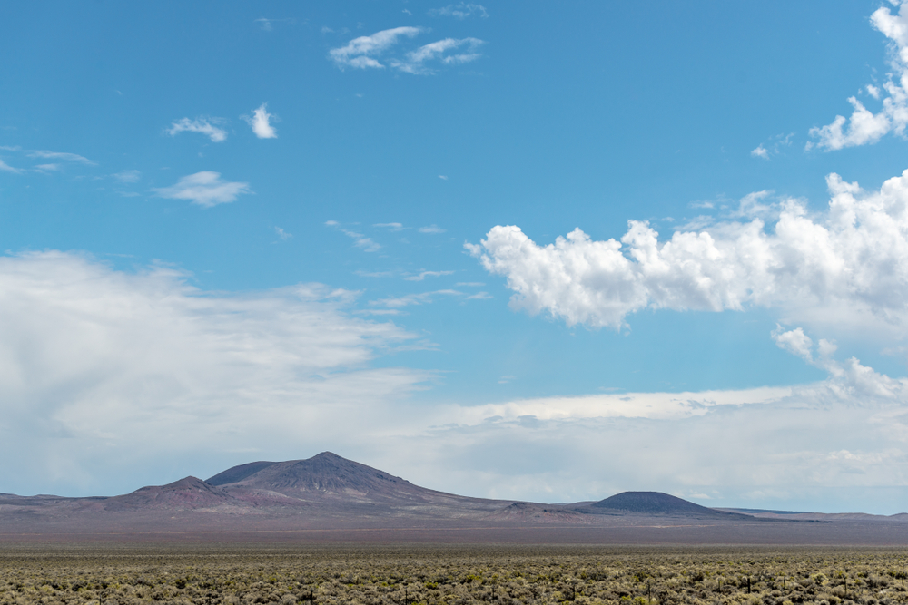 The boundary of the Nellis Air Force Range Nevada Test Site near Area 51 unnamed volcanic buttes beyond the military base border fence