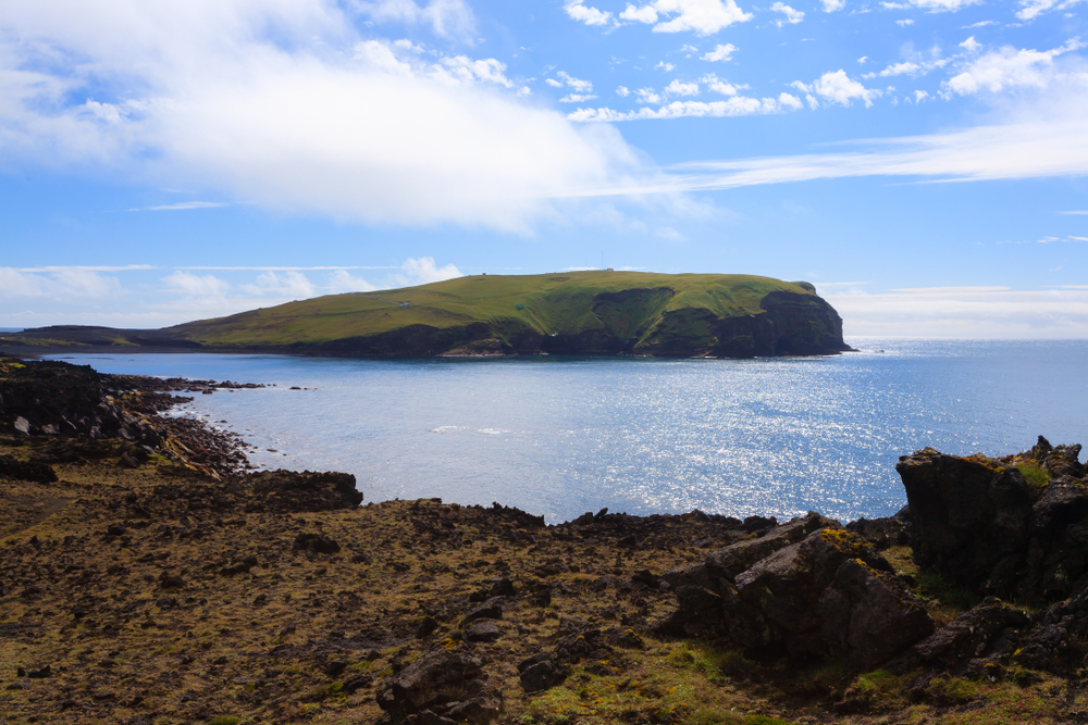 Vestmannaeyjar island beach view with Surtsey island in background. Iceland landscape