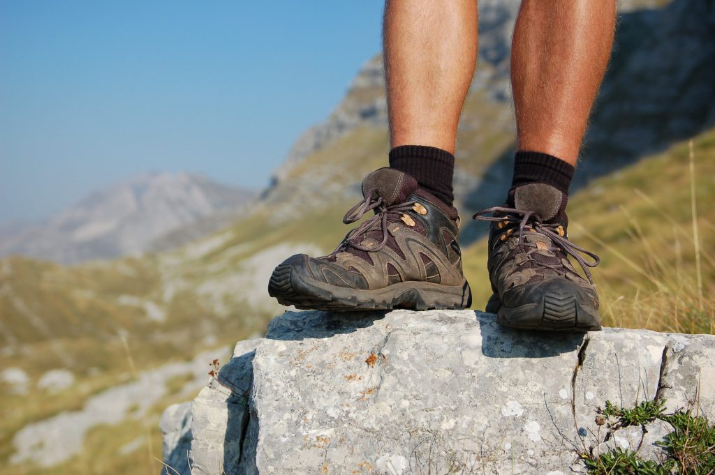 Man on rock hiking boots