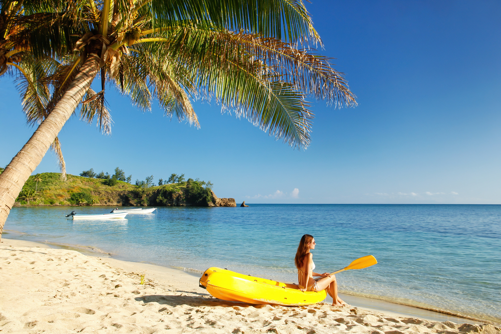 Young,Woman,Relaxing,On,Top,Of,Sea,Kayak,On,The