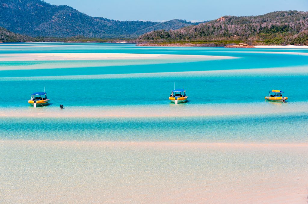 blue water beach with boats