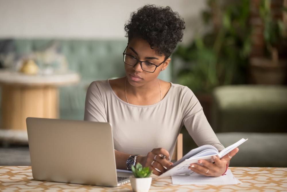 Focused,Young,African,American,Businesswoman,Or,Student,Looking,At,Laptop